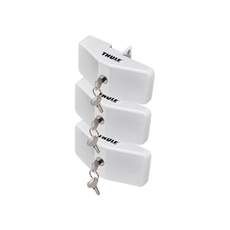 Tre vita Thule rammlås staplade, varje med nycklar. Kompakt, rektangulär design med Thule-logo.
